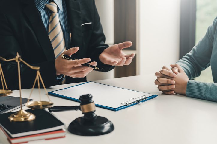 Attorney advising client with gavel and scales