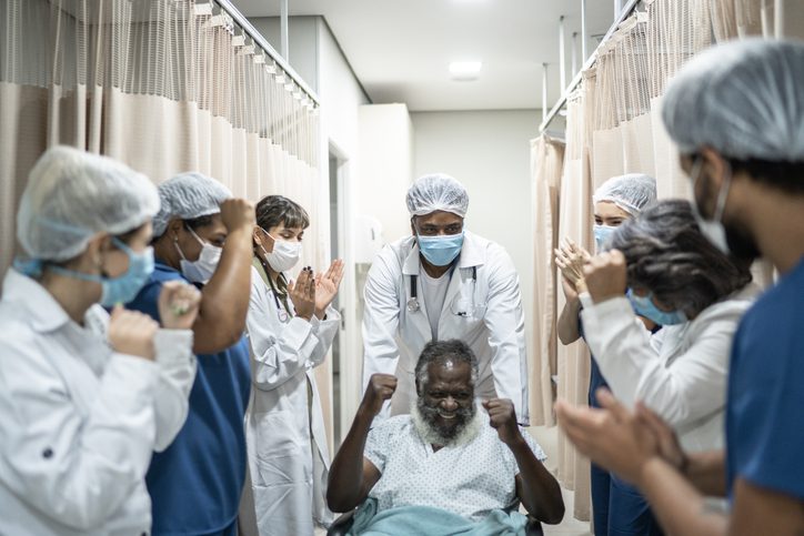 Patient celebrates recovery surrounded by medical team