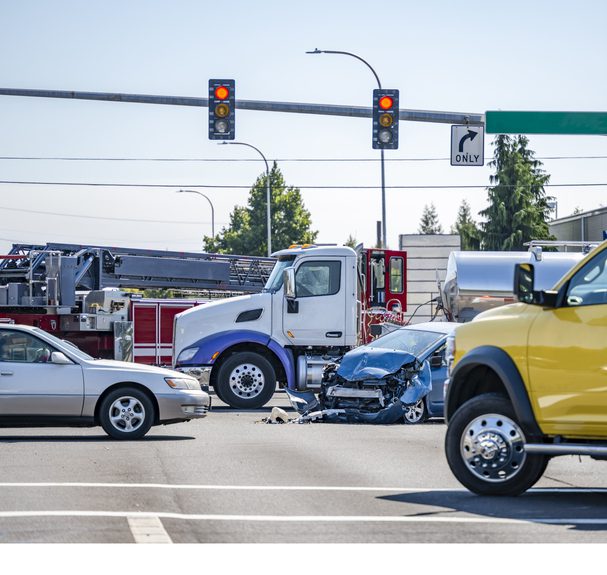 A crowded intersection with several commercial trucks blocking traffic showing how commercial vehicles dominate the roads and cause accidents.